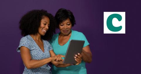 Women looking at a tablet and Clover Health logo