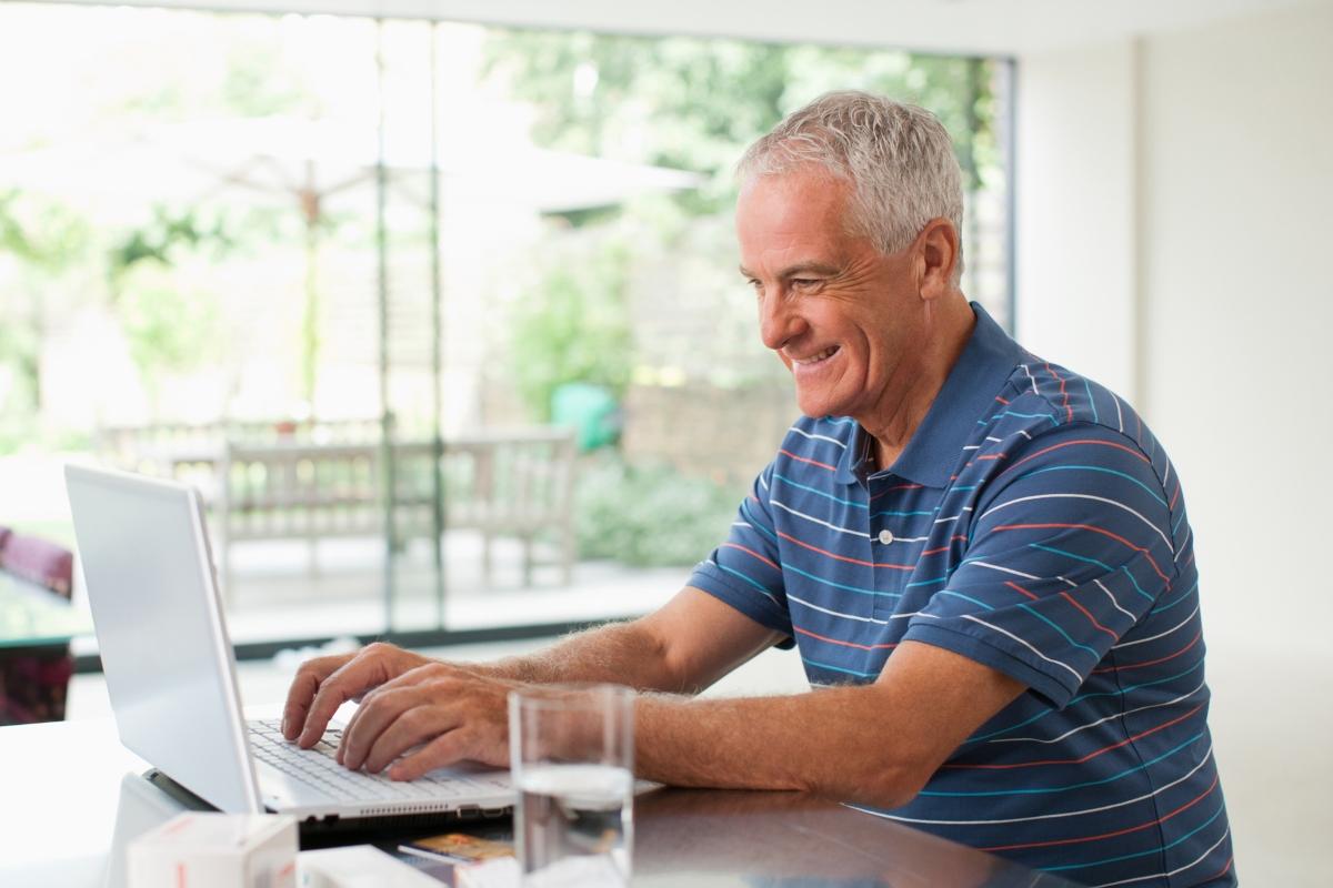 A man using a laptop for zero-based budgeting