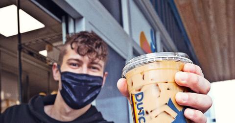Dutch Bros employee handing coffee to someone