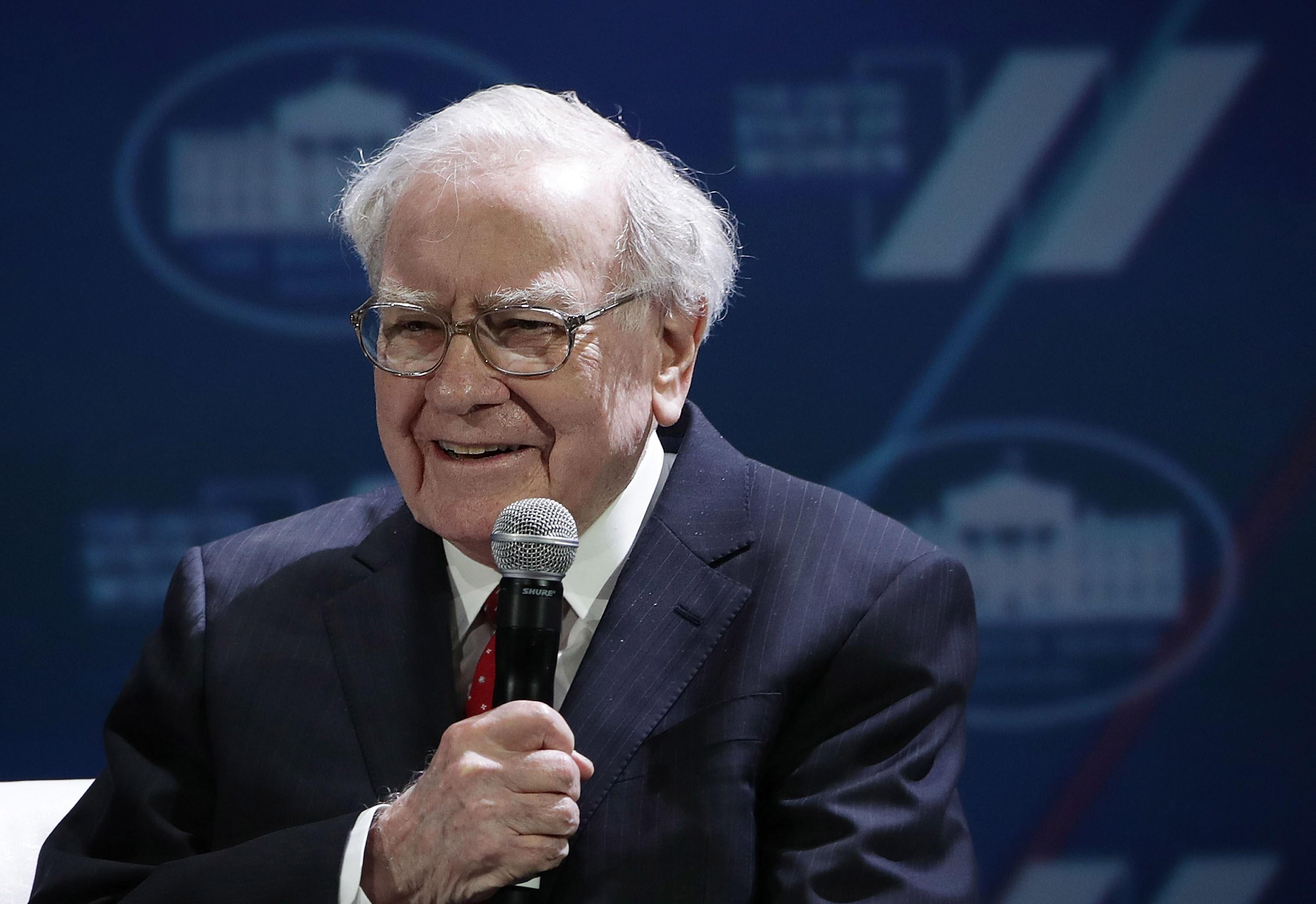 Warren Buffett speaking into microphone