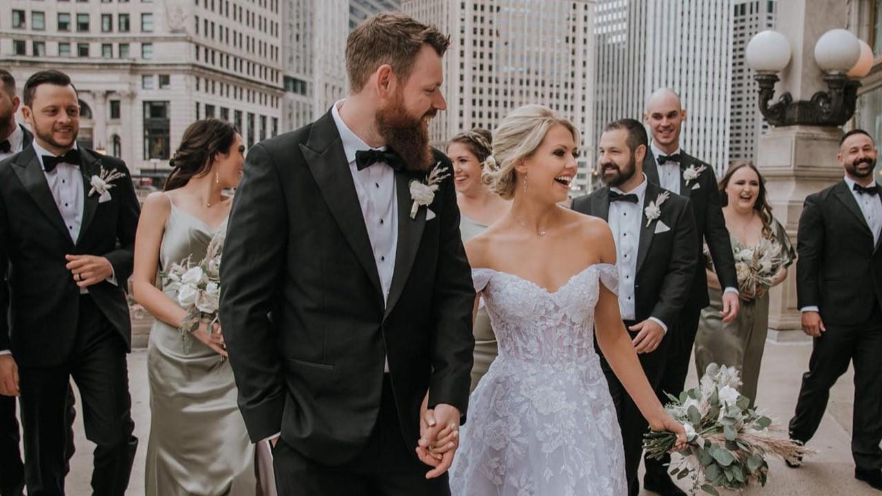 A bride, groom, and wedding party outside wearing clothes from David's Bridal