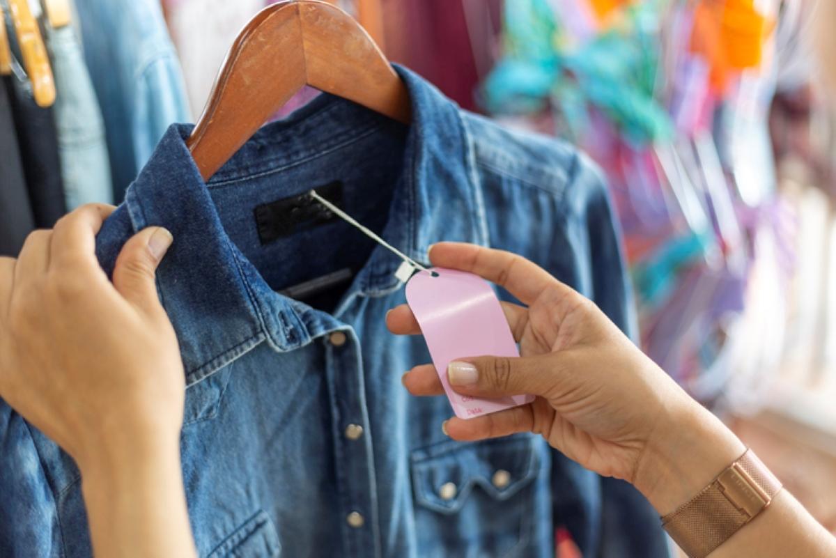 Woman checking clothing price at store