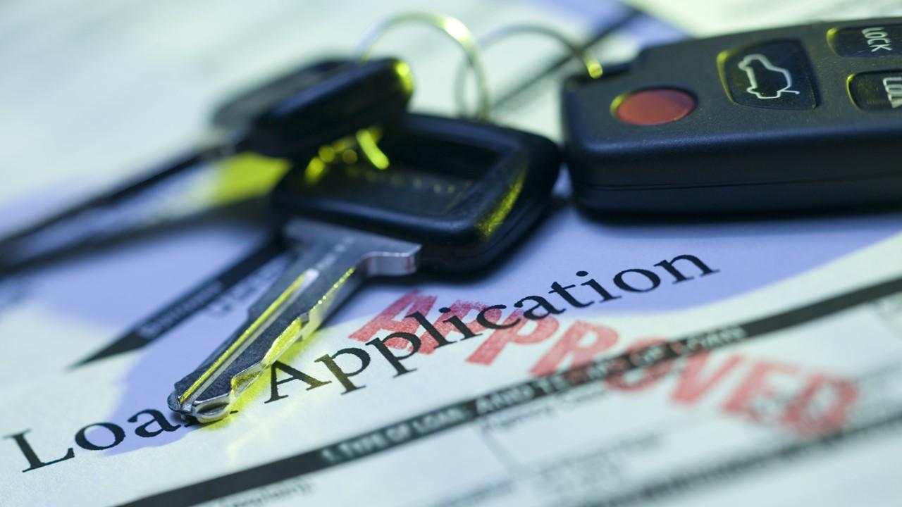 Car loan paperwork and keys