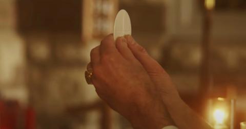 Hands holding communion wafer