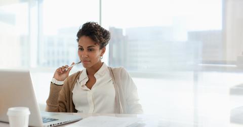 Woman looking at staking pools on a laptop