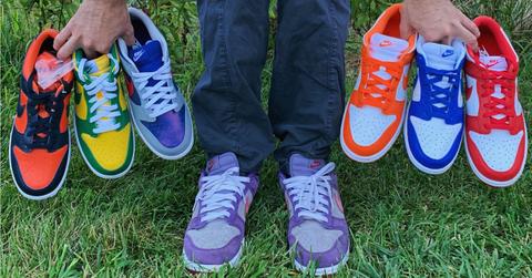 A man wearing and holding Nike shoes