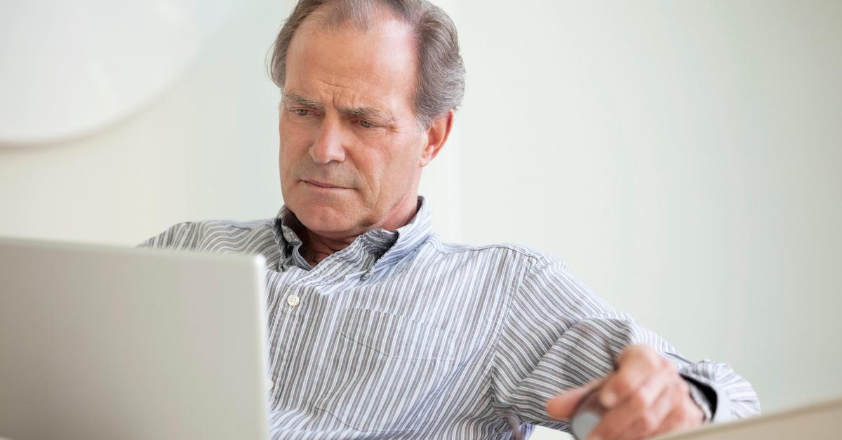 man looks at his computer