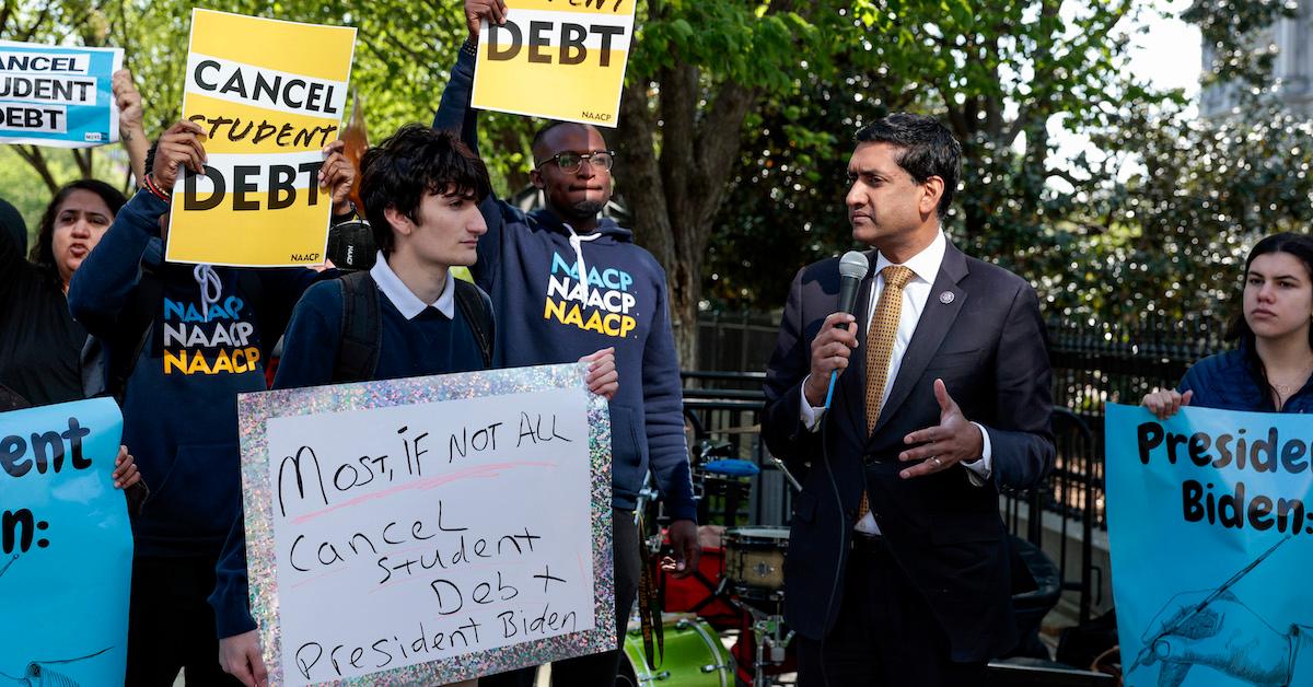 Students hold signs demanding student debt cancelation alongside Rep. Ro Khanna (D-CA) in D.C.