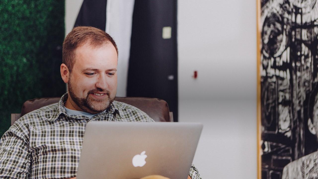 man on mac computer