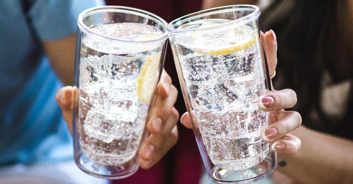 Two glasses of seltzer water with lemon. 