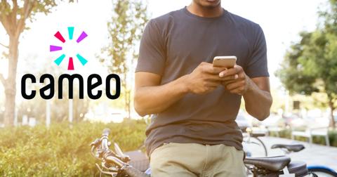 Cameo logo over guy using phone