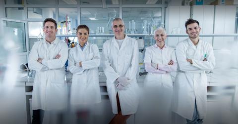 Scientists standing in a lab