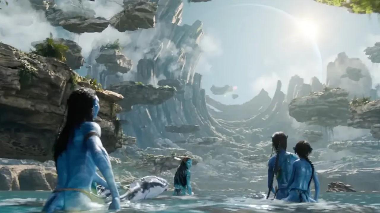 Characters from 'Avatar: The Way of Water' trek through water on Pandora.