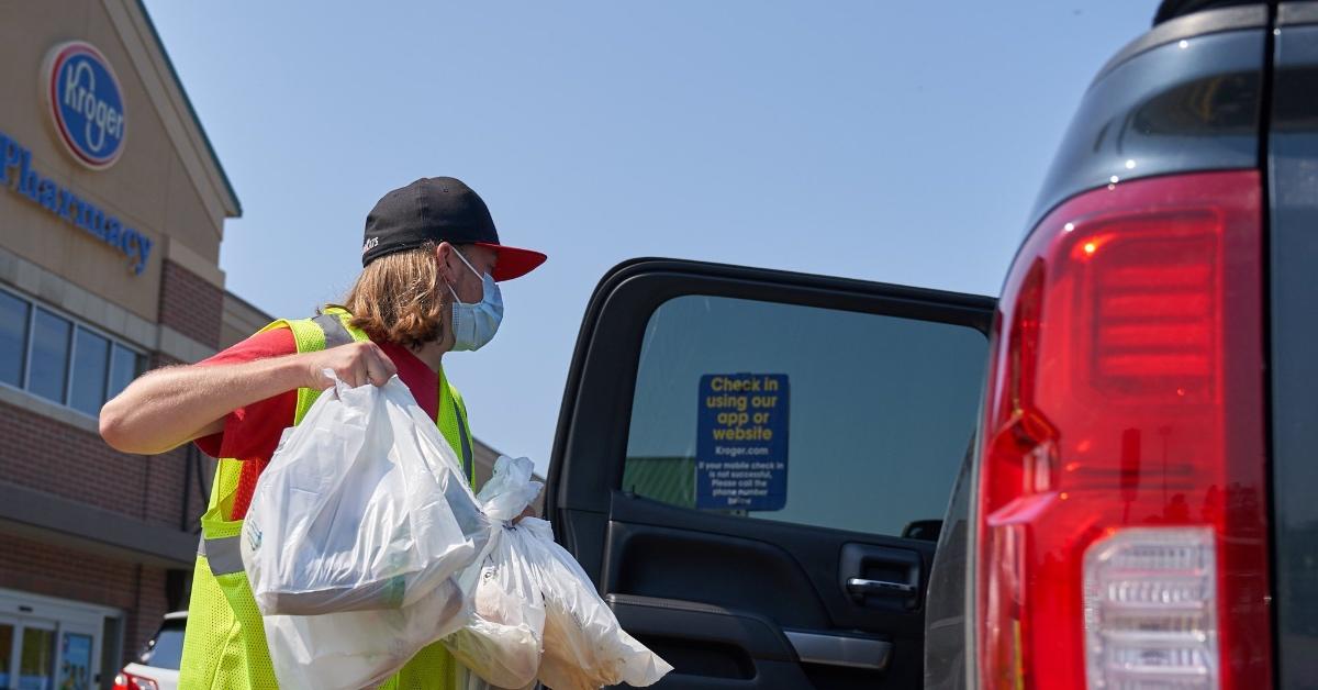 Kroger employee loading groceries in a vehicle