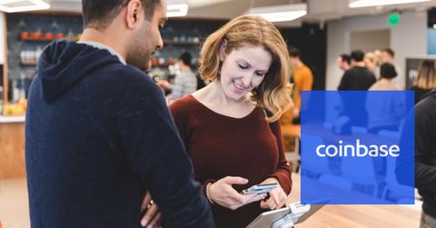 A person using a smartphone at a Coinbase event