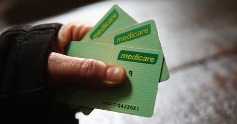 Person holding Medicare cards