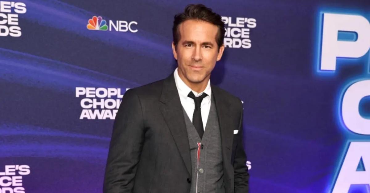 Ryan Reynolds appearing at the People's Choice Awards in December of 2022 in a grey suit.