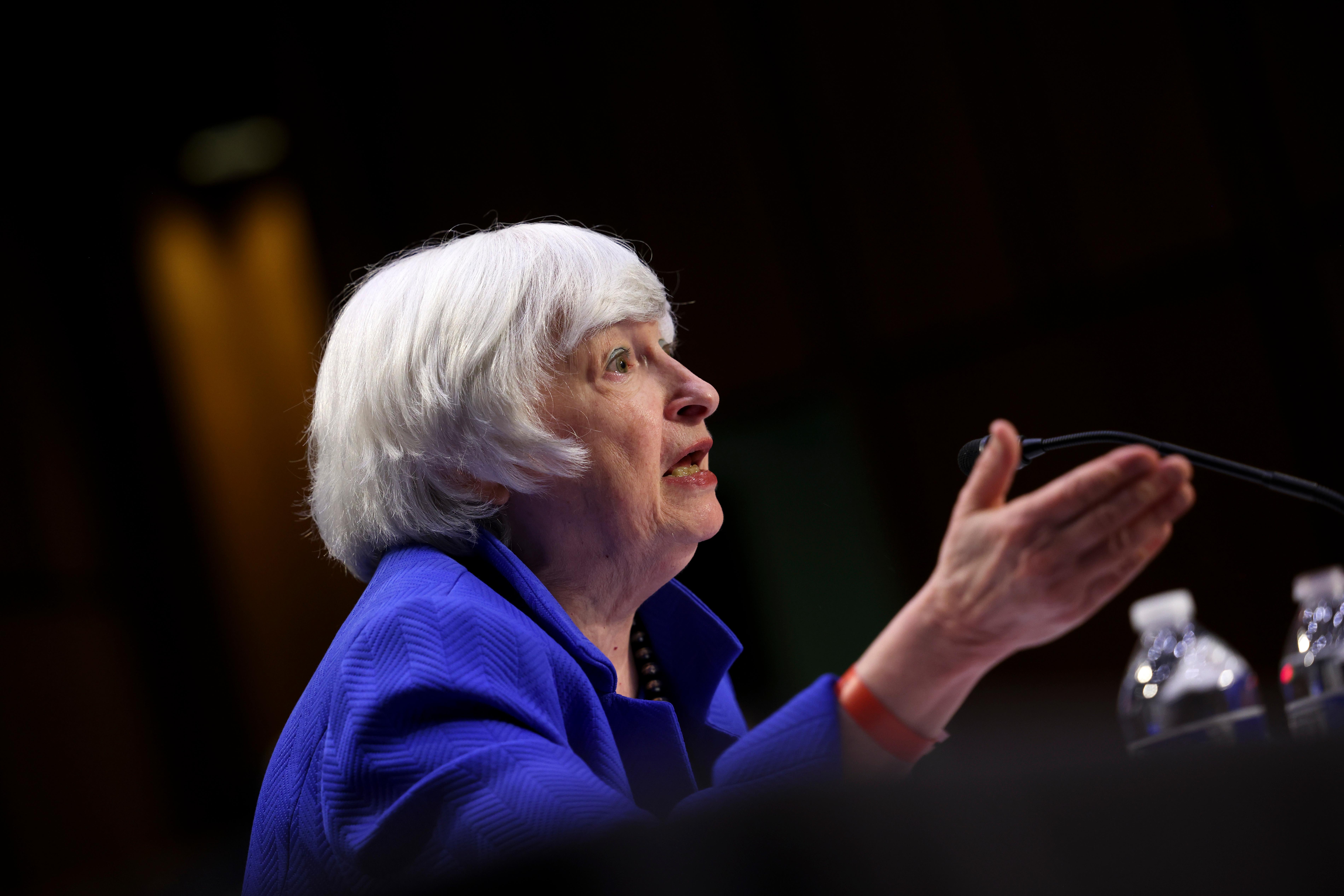 Treasury Secretary Janet Yellen speaking at the podium.