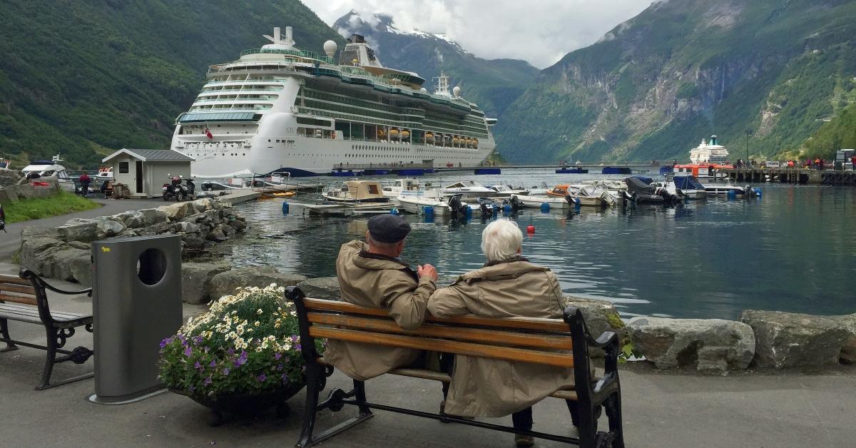 A retired couple sitting on a bench