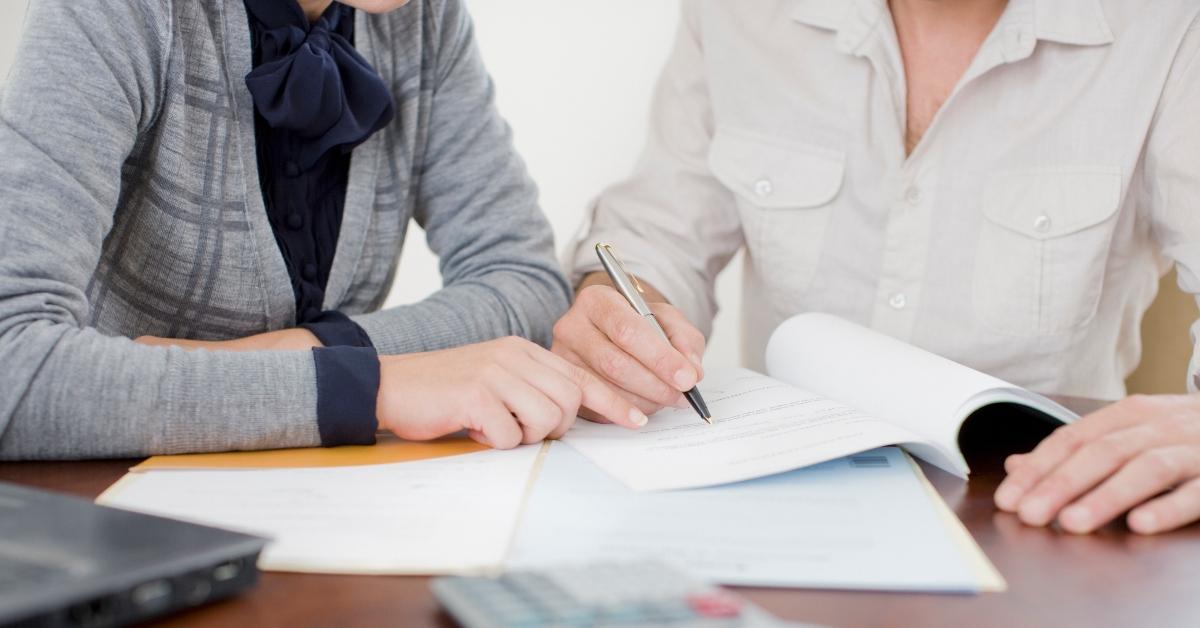 Two people going over financial documents. 