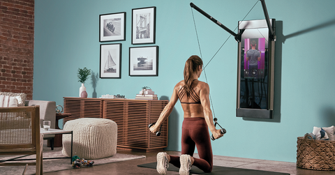 Woman using Tonal equipment to work out