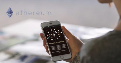 Ethereum logo and a person looking on a smartphone
