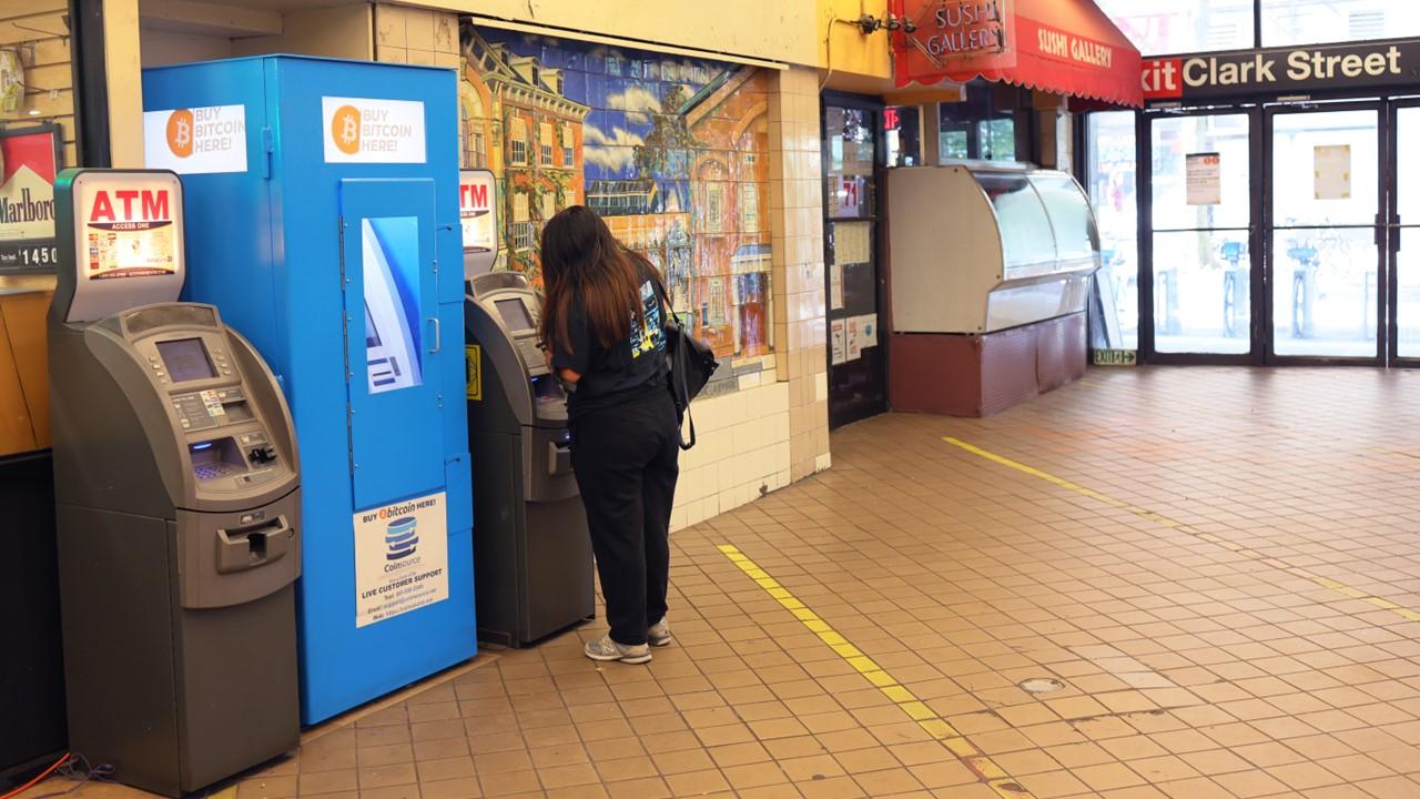 A woman using an ATM.