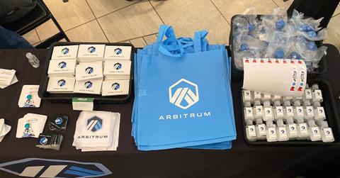 Arbitrum stickers, sanitizer, gum, and a bag to hold it all