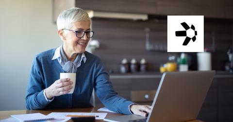 Woman looking on a laptop and Quant logo