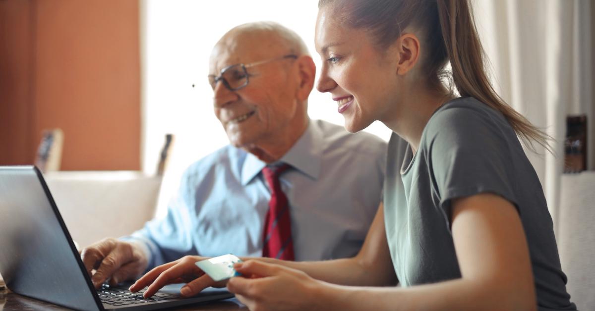 A woman works with her tax preparer to pay taxes online.