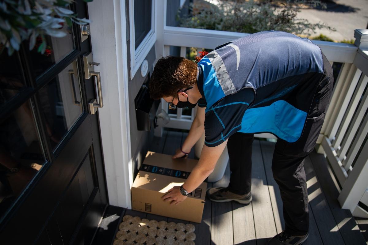 delivery driver placing package on front porch