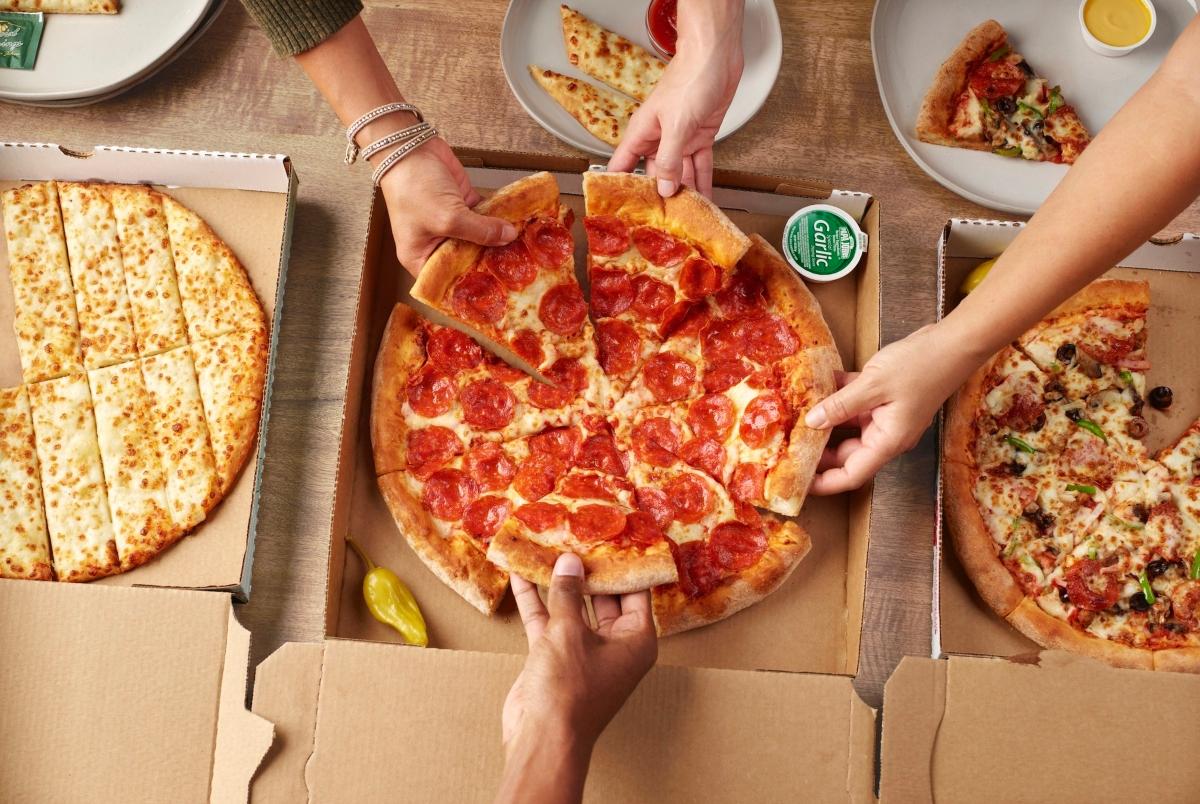 Teens eating Papa John's pizza