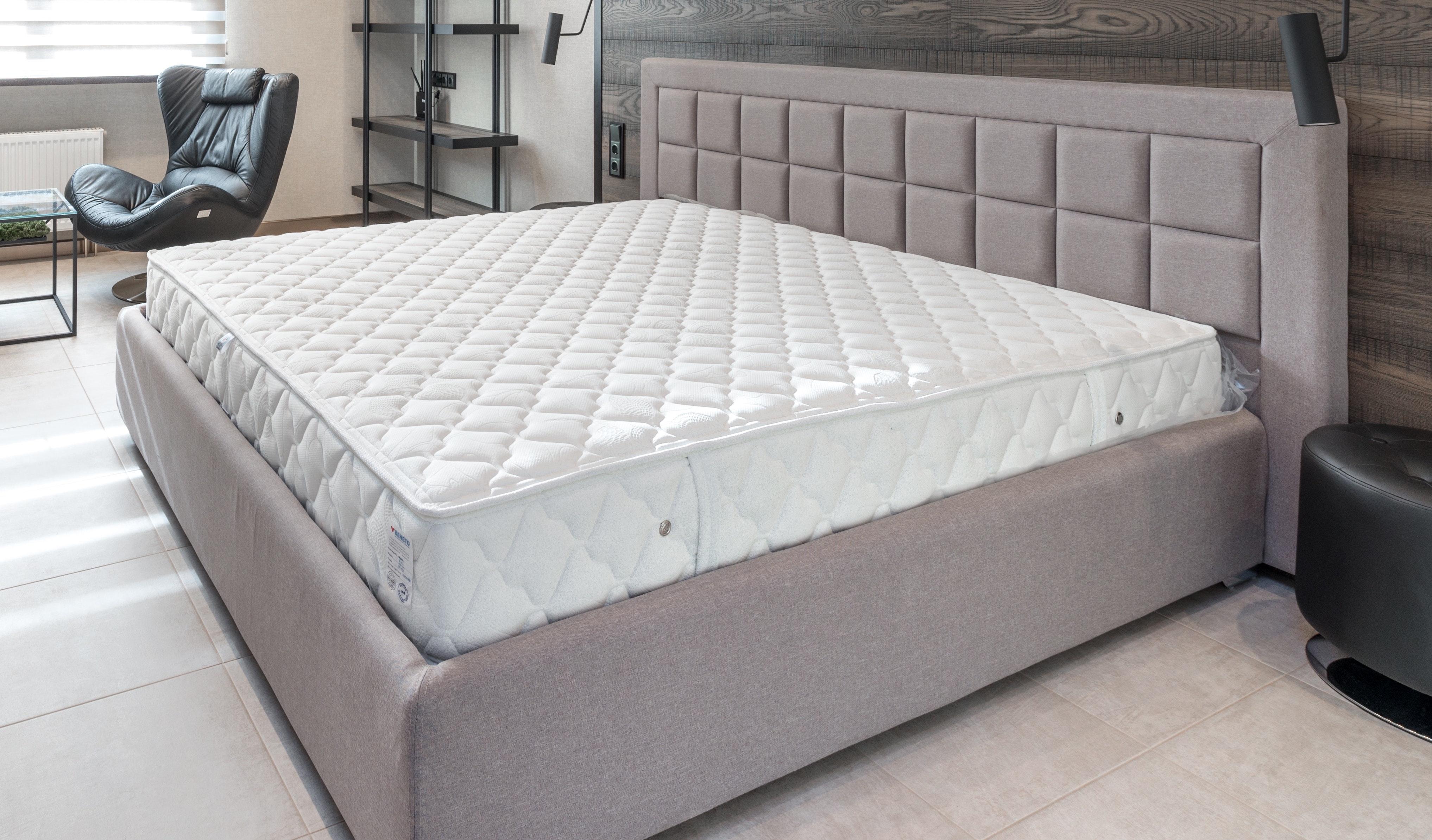A mattress in a cushioned bed frame
