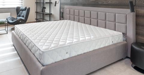 A mattress in a cushioned bed frame
