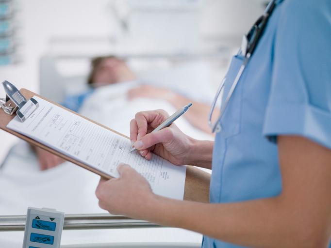 A nurse filling out paperwork.