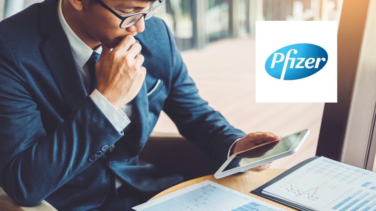 Man looking at data and Pfizer logo