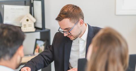 Real Estate Agent Discussing in Front of His Client