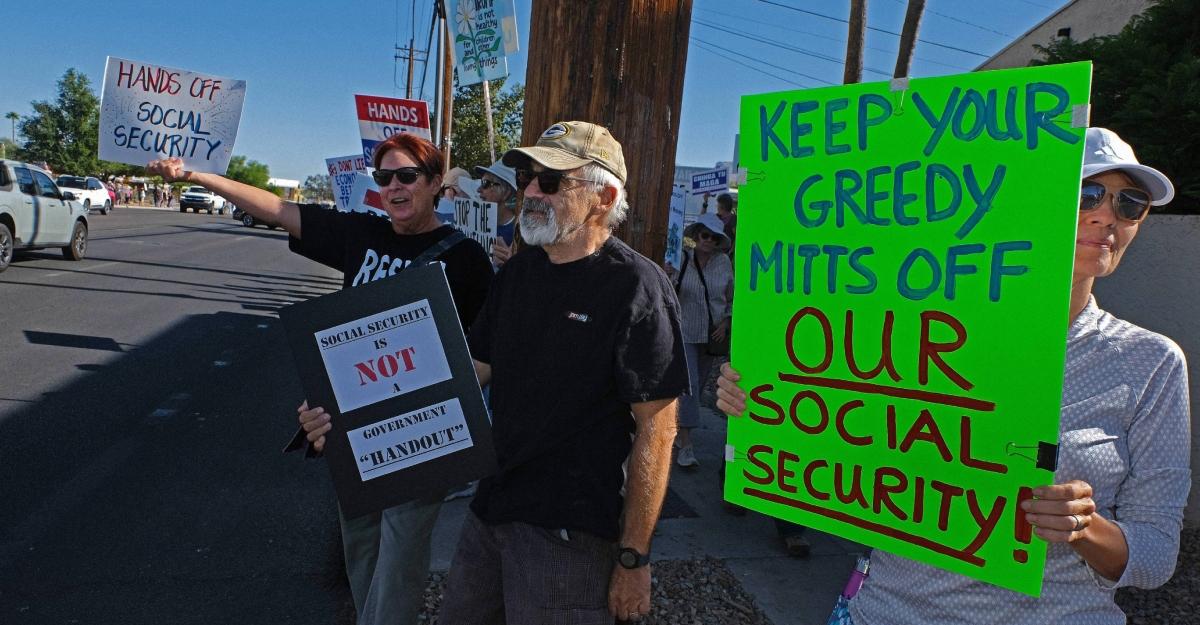 Protestors hold up signs fighting against cuts to Social Security.