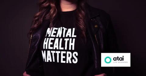 Woman wearing a mental health matters t-shirt and Atai Life Sciences logo