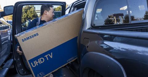 Man loading a TV in his truck