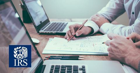 People reviewing tax data and the IRS logo