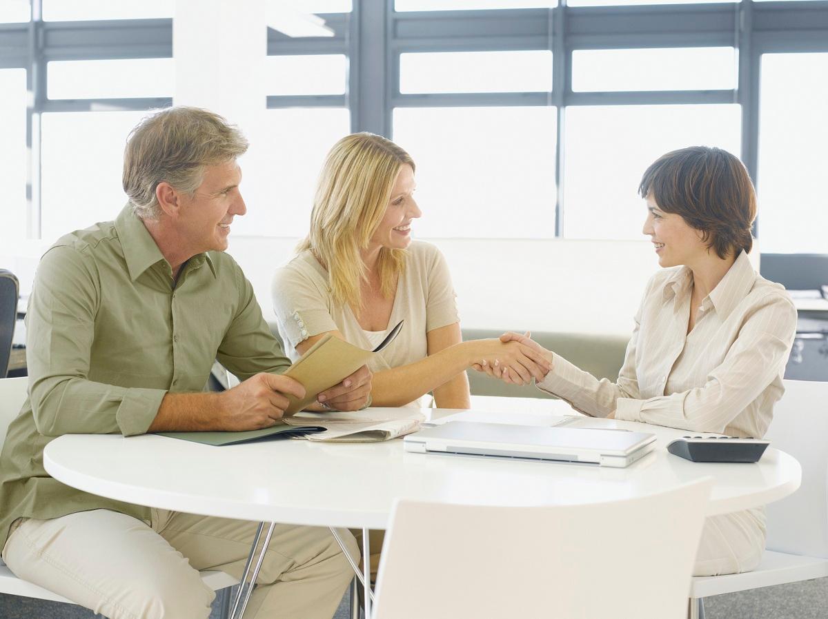 Couple greeting financial advisor