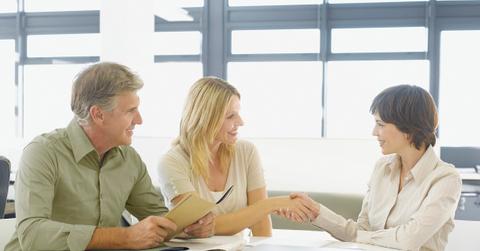 Couple greeting financial advisor
