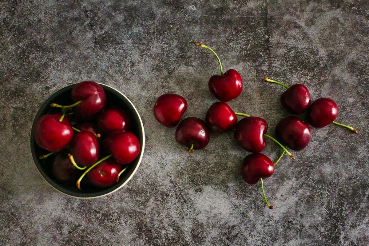 Red cherries on a stone surface