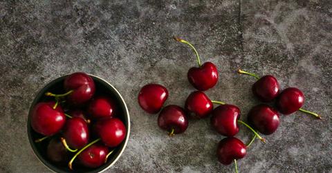Red cherries on a stone surface