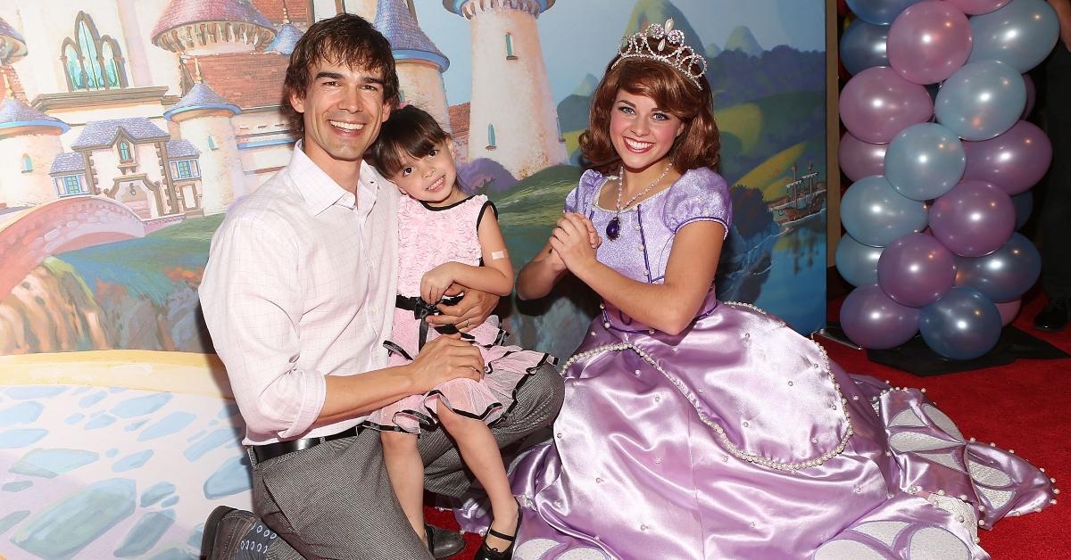 A princess with little girl and her dad at a party