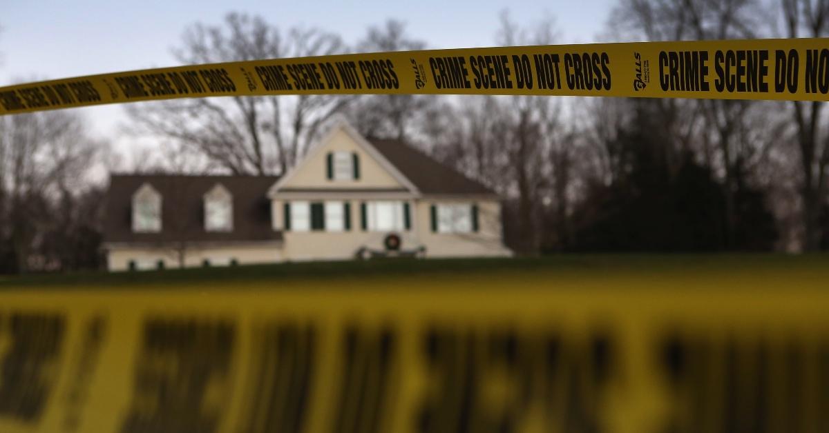 Police tape stretches across the front yard of the Lanza residence