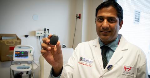 A person showing the Eversense CGM system