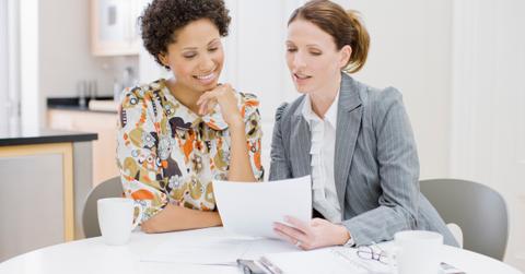 Two businesswomen reviewing papers