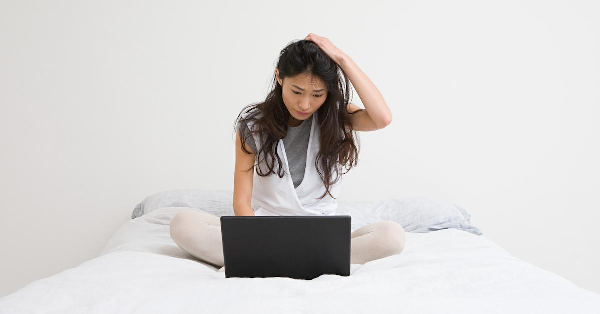 A woman looking at driveway rentals on a laptop